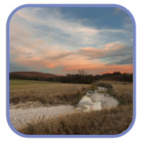dry creek bed through the Flint Hills with a sunset