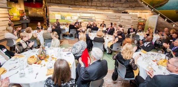 People seated at tables at an event 